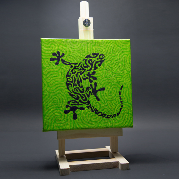 Photo of gecko painting on easel